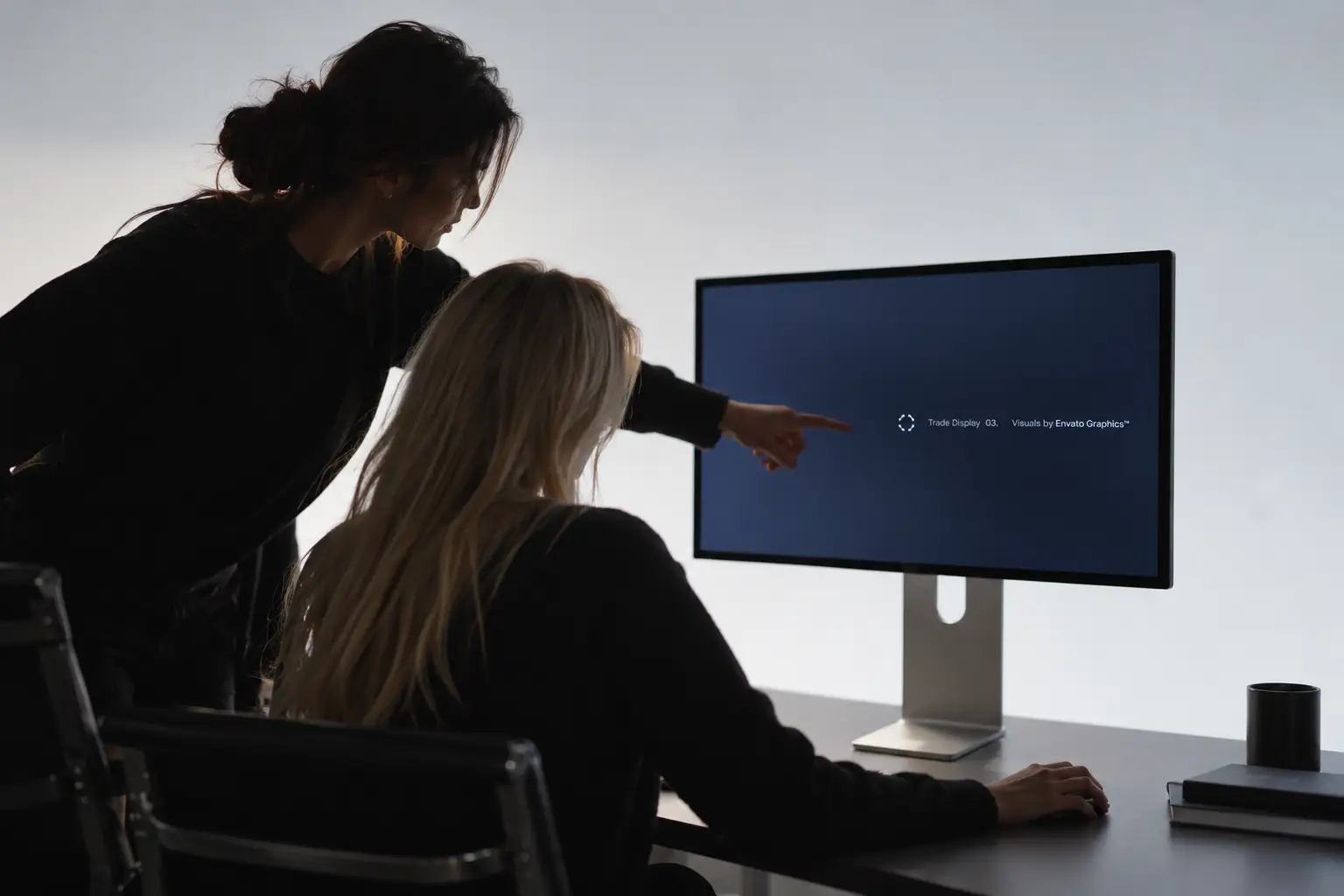 Two colleagues looking at a screen together